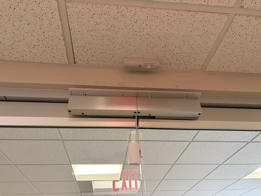 Double magnetic lock installed above interior glass doors