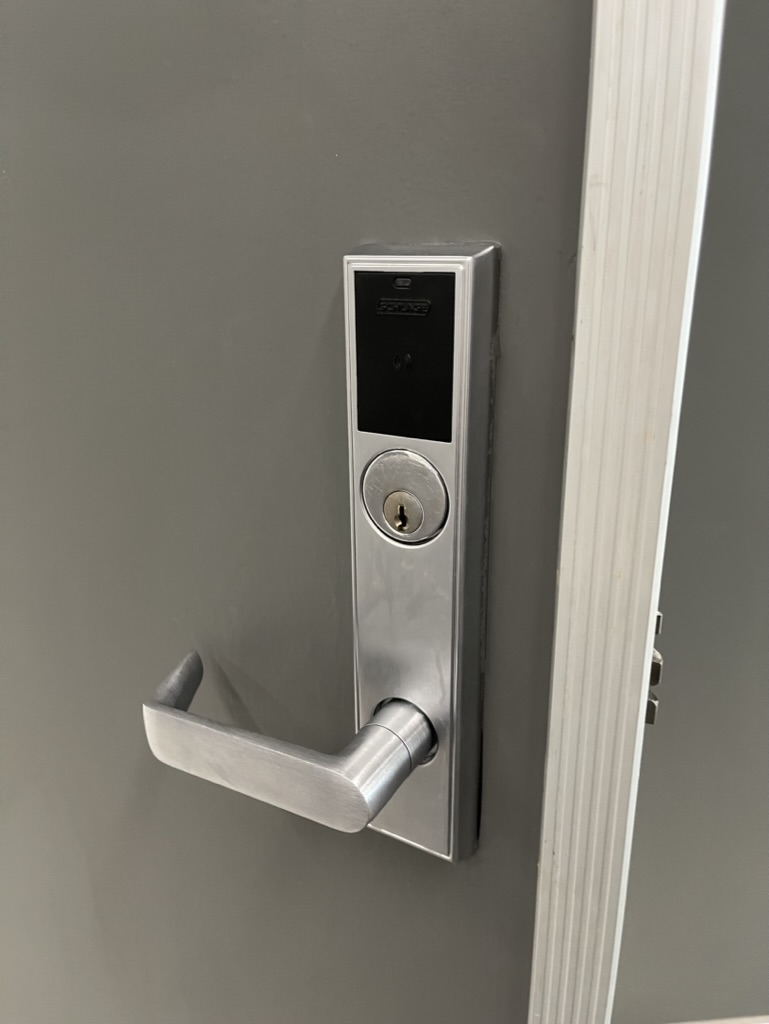 Electronic mortise lock with card reader installed on a commercial door