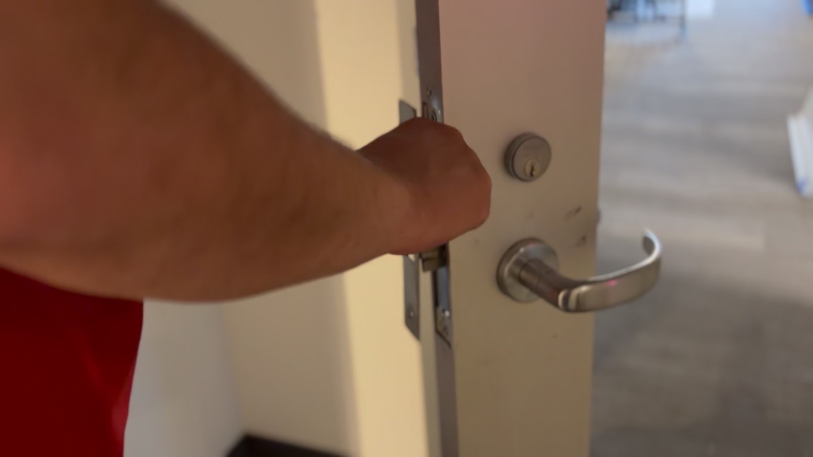 Testing a mortise lock and lever set on a newly installed office door