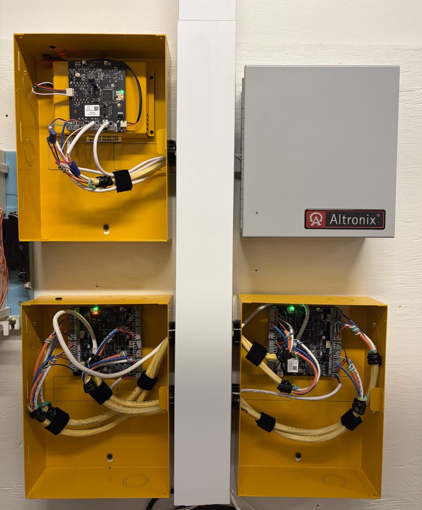 Open ProDataKey enclosures showing neatly wired controller boards beside an Altronix power supply