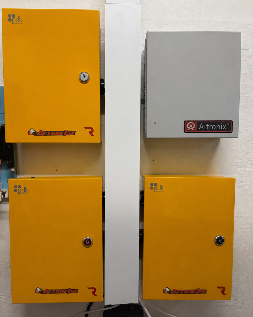 Three ProDataKey access panels and an Altronix power supply mounted on an equipment wall