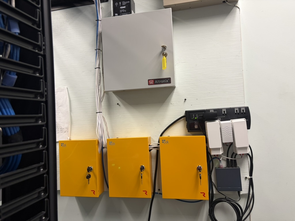Three ProDataKey door controllers and power supply wired in an equipment room